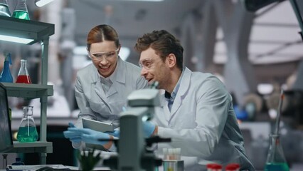 Happy laboratory colleagues working in clinic close up. Scientists giving five