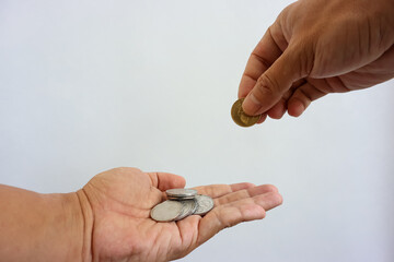Man hand giving coin to woman hand isolated on white background. Giving, taking, charity or...