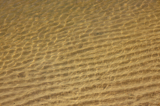 Soft undulations of the sand formed by the water of the coast.