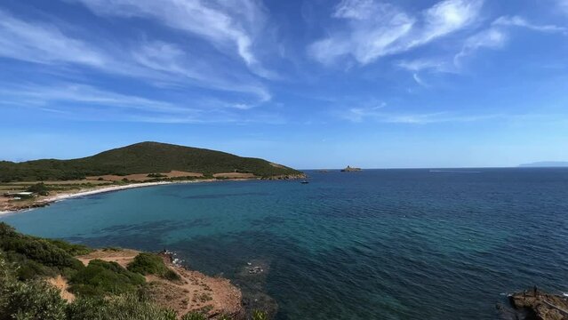 Summer season at Tamarone beach in Corsica island, France. Panning view