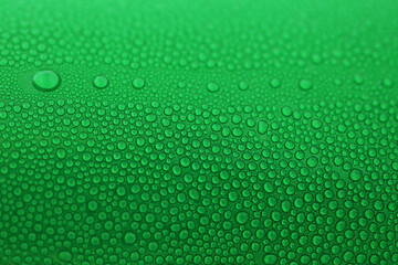 water drop on green beverage cans background, texture of cold aluminium drink package