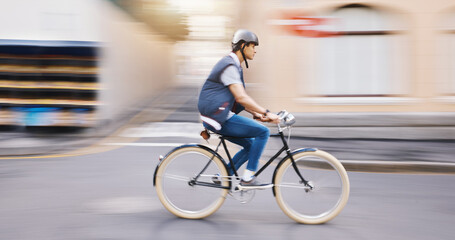 Student man, bike and city in motion blur, speed and sustainable travel in street for fitness in summer. Young guy, retro bicycle and fast with eco friendly transport in metro, road or outdoor in cbd