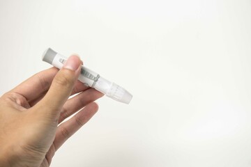 Female hand with lancet pen on white background. Diabetes concept
