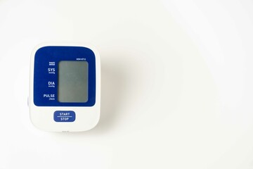 Fototapeta premium Automatic portable blood pressure machine with arm cuff isolated on white with copy space, studio shot. tonometer, hospital, research