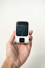 man's hand holding glucose meter isolated. Diabetes concept. Diabetes concept