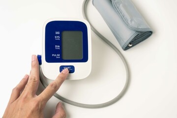 female hands check blood pressure monitor and heart rate monitor with digital manometer, isolated...