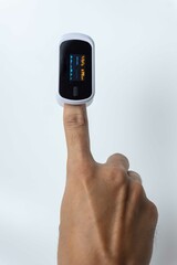 Close up of human finger while using Pulse Oximetry isolated on white background.