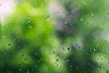 View of glass with water drops on window bedroom, closeup. Rain drops sliding on window glass