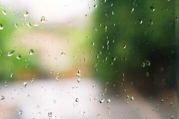 View of glass with water drops on window bedroom, closeup. Rain drops sliding on window glass
