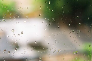 View of glass with water drops on window bedroom, closeup. Rain drops sliding on window glass