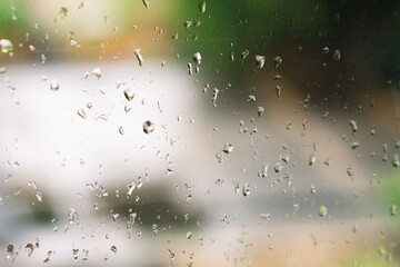 View of glass with water drops on window bedroom, closeup. Rain drops sliding on window glass