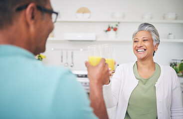 Senior couple, smile and juice cheers in a kitchen with toast and love celebration drink. Home,...