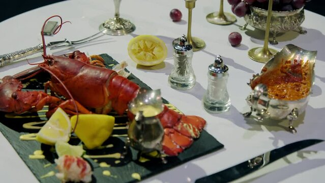 Wide shot of a red lobster on a plate, white table food concept 