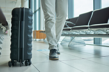 Travel, suitcase and person legs walking to flight, international opportunity and global journey in lobby. Luggage, entrepreneur or business man at airport for vacation, travel agency or hospitality - obrazy, fototapety, plakaty