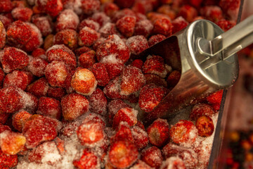 Frozen strawberries in a refrigerator in a supermarket. Ready-made semi-finished products for a...