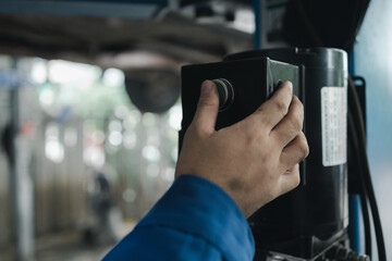 The mechanic is repairing the engine, A car repair worker is inspecting a car, A car mechanic is looking at what is the problem with the engine in the garage.