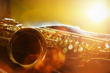 close up of a saxophone in open case on table against widow light effected, copy space for music...