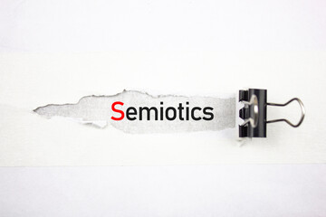 Semiotics text, acronym on a torn sheet. SEMIOTICS word scientific concept. - obrazy, fototapety, plakaty