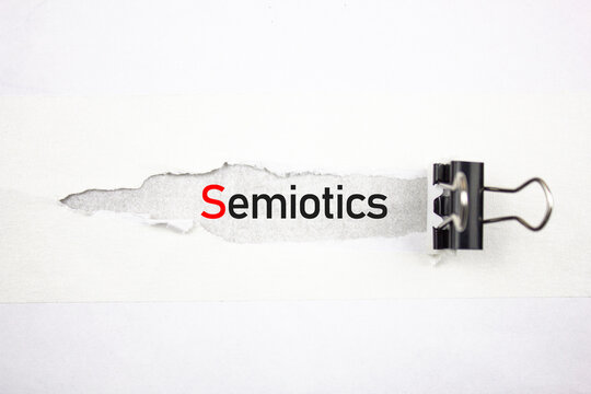 Semiotics text, acronym on a torn sheet. SEMIOTICS word scientific concept.