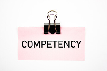 COMPETENCY acronym, text on paper with a clip. Competency, specialist, solution, concept.