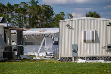 Property damage from strong hurricane winds. Mobile homes in Florida residential area with destroyed rooftops. Consequences of natural disaster