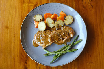 Butter Chicken Steak with vegetables and herbs
