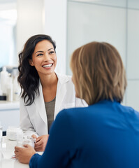 Fototapeta premium Young Smiling Dermatologist chatting with a patient
