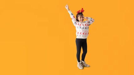 Cheerful young Asian girl wearing a Christmas sweater with reindeer horns, Happy smiling...