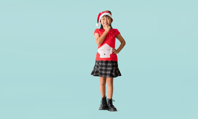 Cheerful young Asian girl wearing a Christmas sweater with reindeer horns, Happy smiling standing with Looking surprise posing full body portrait, isolated on blue background