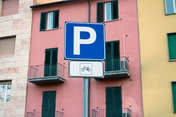 Fotobehang Blue bicycle paring sign and building © vaakim