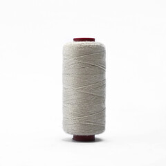 Grey thread and needle over white