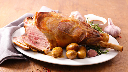 Roasted goat leg with potatoes and herbs
