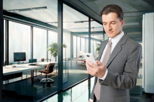 Smiling mature businessman posing in office with phone, AI generated image