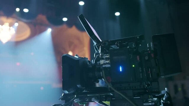 Professional digital cinema camera with set of light hanging in studio background. move camera footage Naperville IL USA 5 May 2023