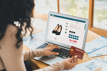 Woman shopping online on internet marketplace browsing for sale items for modern lifestyle and use...