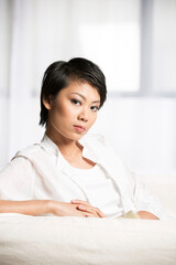 Chinese woman at home on the sofa.