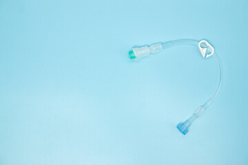 Extension tube with connector for intravenous catheter on blue background,top view - obrazy, fototapety, plakaty