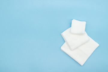 Gauze in square shape multiple size isolated on blue background,top view