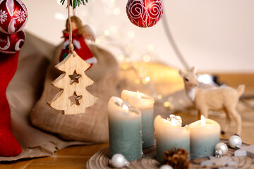Winter holidays concept. A wooden tree on a Christmas tree on a background of lights