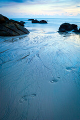Time-lapse of beach at dusk with footprints in sand in Langkawi, Malaysia
