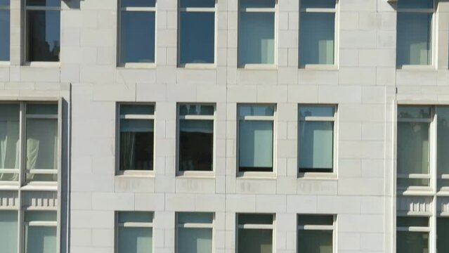 Aerial view in front of windows of a tall apartment building in sunny New York