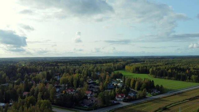 Panoramic drone shot of the rural town of Kerava, a roadside village in southern Finland, sun hidden in the clouds.