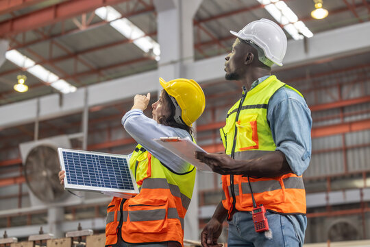 Factory metal workers install solar panels, cut costs, earn carbon credits, combat climate change.