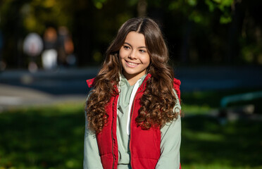 Fototapeta premium happy curly teen girl outside. curly teen girl portrait. photo of curly teen girl. curly teen girl