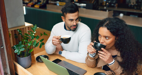 Obraz premium Coworkers, laptop and remote work with coffee, working and technology for business, strategy and planning. Cafe, meeting and brainstorming for project, woman and man in partnership, listening and job