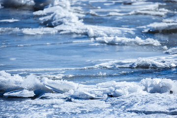 Fototapeta na wymiar Frozen sea surface with fragments of ice, natural background photo