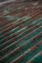 The roof of the house made of zinc looks dirty and rusty