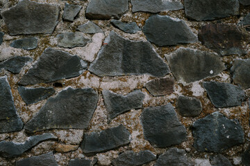 Several large stones are arranged and cemented for a building wall to make it stronger and stronger