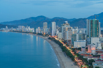 Nha Trang city with buildings and beach view during twilight.