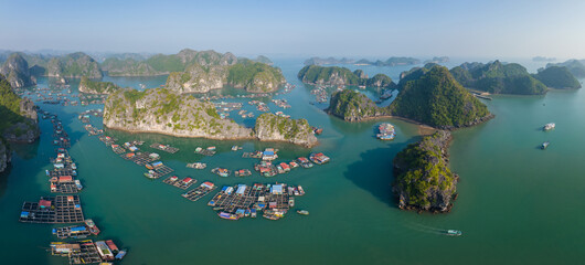 Floating fishing village in Lan Ha Bay, Vietnam viewed from above. Famous tourist destination in...